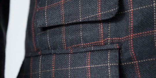 Close-up of a ticket pocket of a bespoke silk suit